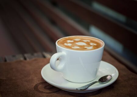 Coffee latte in white glass,wooden backgroundの写真素材