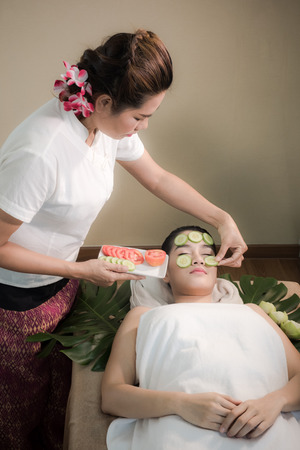 Face treatment With cucumber and fresh tomatoes.の写真素材