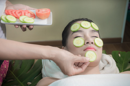Face treatment With cucumber and fresh tomatoes.の写真素材