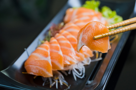 Salmon Sashimi on Black Ceramic Plat,black background.の写真素材