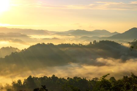 Beautiful Landscape of mountain layer in morning sun ray and winter fog.の写真素材