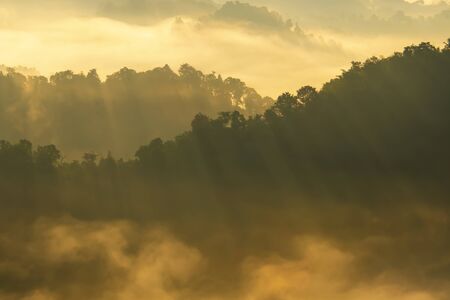 Beautiful Landscape of mountain layer in morning sun ray and winter fog.の写真素材