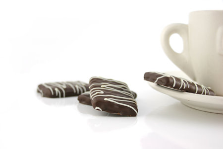 Cup of Coffee with some luxury chocolate mintsの写真素材