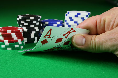 Big Slick - Ace King with poker chips on a green poker baize
