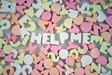 Loads of coloured Candy Letters with HELP ME spelled out in the middle の写真素材