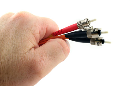 Fiber Optic Computer Cable held in the Hand isolated on a white background