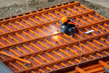 A construction worker do a job such as painting welding in a construction site.の写真素材