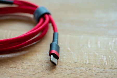 The usb type c is a hi speed data transfer and quick or fast charge battery.It a new connector port fo a computer , laptop, or cell phone.A red cable plug to notebook.の写真素材