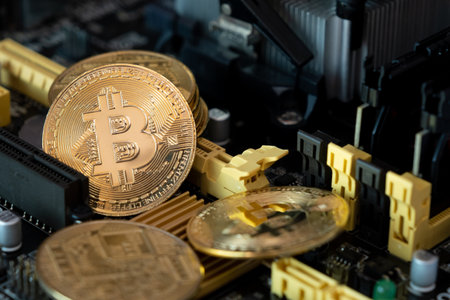 Golden bitcoins on a computer  main board . Crypto currentcy coins on  mother board background.