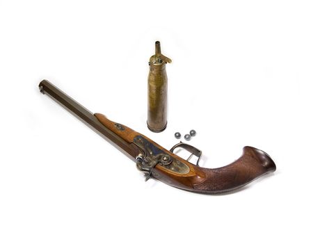 Antique handgun with bullets and can with black powder.の写真素材