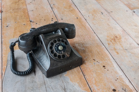 Old telephone with wood backgroundの写真素材