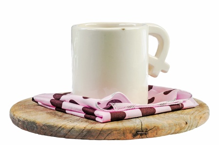 A white cup of coffee on pink napkin on the wood isolated white backgroudの写真素材