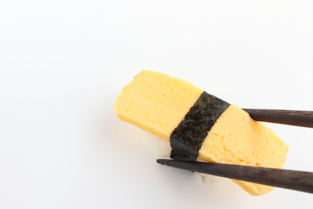 Sushi in chopsticksの写真素材