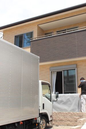 Newly built houses and moving trucksの写真素材