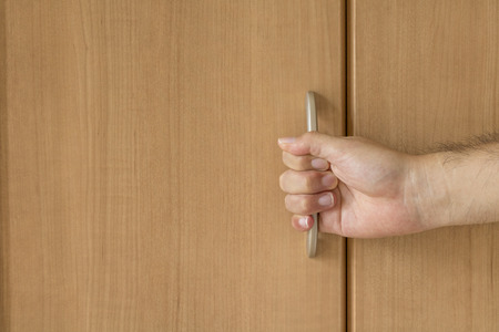 Closet and man's handの写真素材