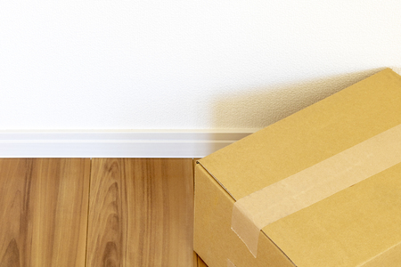 Room of newly built house and cardboard box