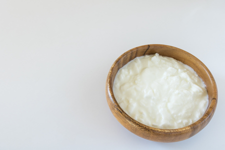 Yogurt in a wooden dishの写真素材