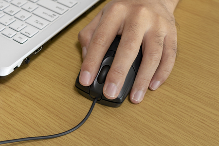 Image of a man operating a laptop computer