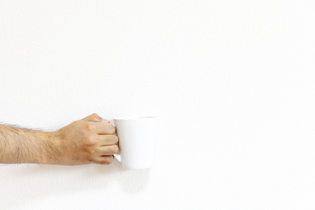 Male hand with white mugの写真素材