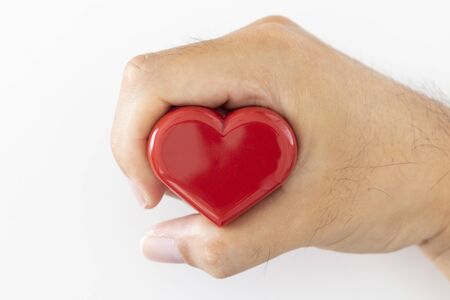 Male hand holding a heartの写真素材