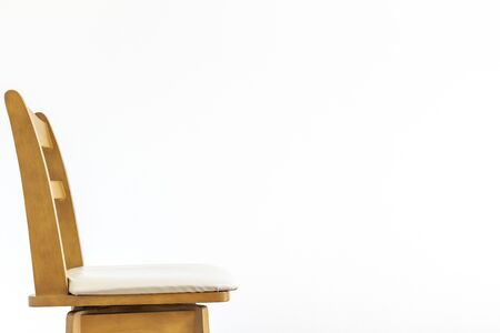White wall and wooden chair