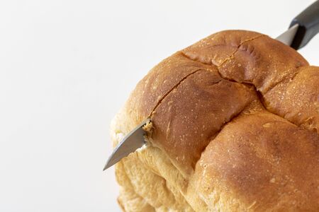 A loaf of bread and a bread knifeの写真素材