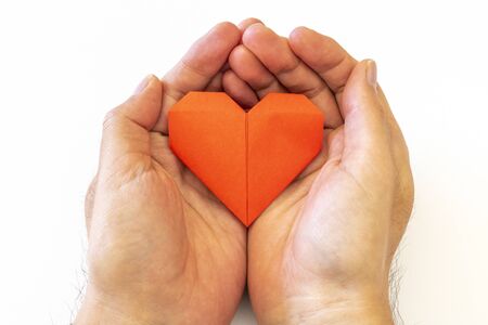 Man hand with heart made of origamiの写真素材