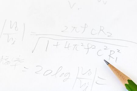 Pencil and formulas written on paperの写真素材