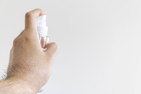 Hand of man holding spray bottleの写真素材