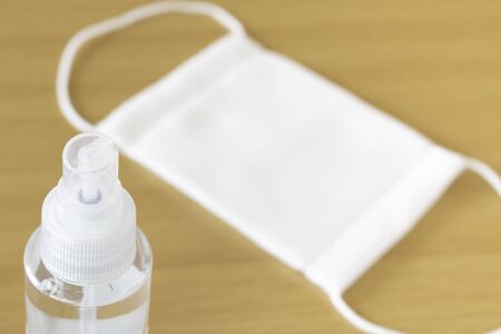 Image of disinfecting a cloth mask with alcohol spray
