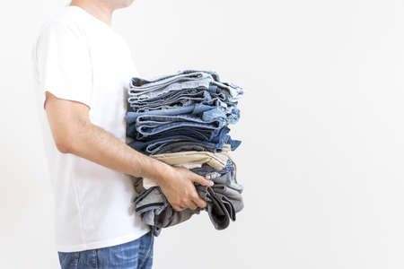 Men carrying laundry with folded clothing