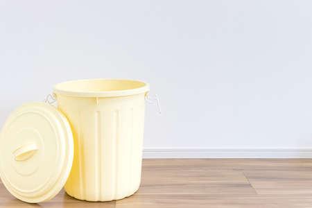 A yellow 45-liter trash can placed indoors