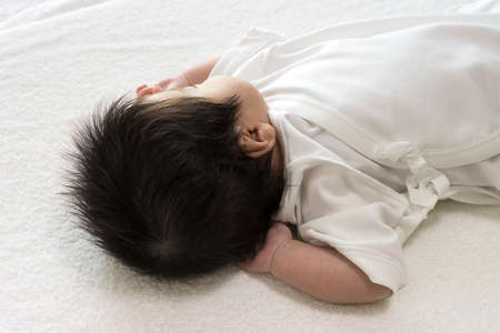 Photo taken from the side of the sleeping baby's head