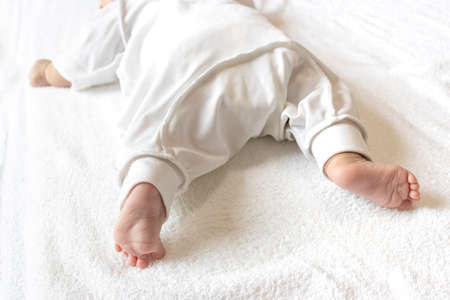Lower body of a two-month-old baby lying prone