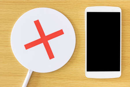 Smartphone on the table and false sign