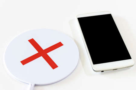 Smartphone and false sign taken with white backgroundの写真素材