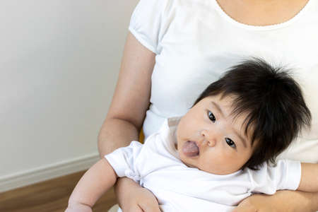 A mother holding a  baby