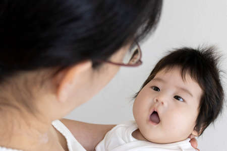 Mother and baby staring at each otherの写真素材