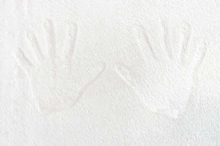 Traces of a man's hand on a white carpetの写真素材