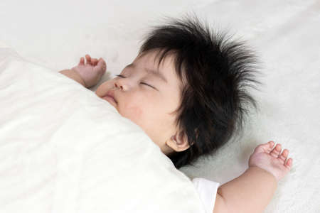 Baby's face sleeping on a futon, 0 years old, 4 months old, girl