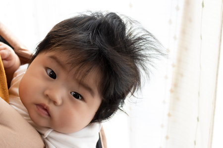 Baby piggybacked (0 years old, 5 months old, girl)の写真素材