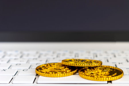 Stacked gold coins and laptops, business imageの写真素材