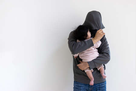 Image of a baby being kidnapped by a suspicious man (0 years old, 7 months old, girl, Japanese)の写真素材