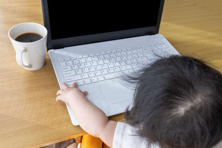 A baby using a laptop. Image of digital native generation (0 years old, 7 months old, girl,...