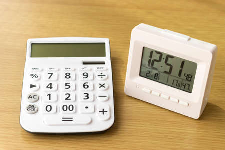 Calculator and clock. The time is money