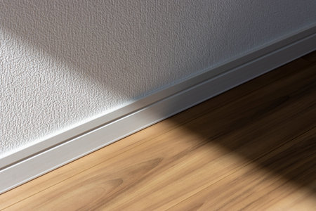 The boundary between the flooring and the wall. sunlight