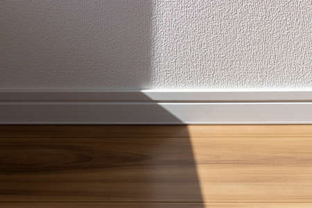 The boundary between the flooring and the wall. sunlight