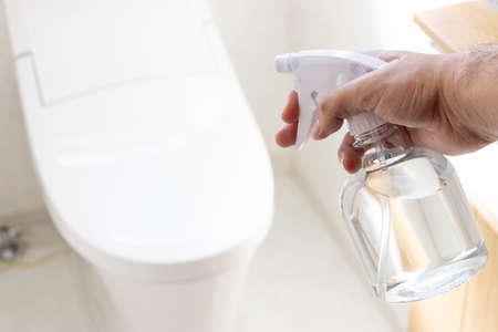 A man who disinfects his toilet with alcoholの写真素材