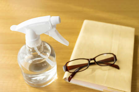Image of alcohol disinfecting books and glassesの写真素材
