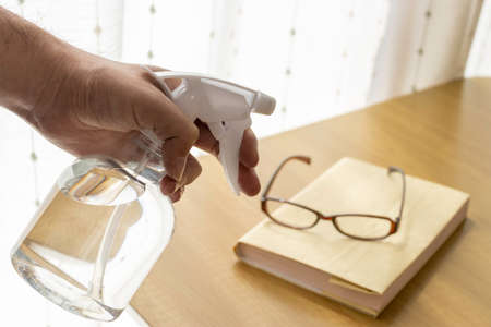Image of alcohol disinfecting books and glassesの写真素材